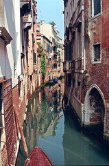 Fototapeta na wymiar View of the narrow Canal and the colorful Venetian houses along the canal in Venice, Italy.