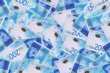 200 Israeli new shekels bills lies in big pile. Rich life conceptual background