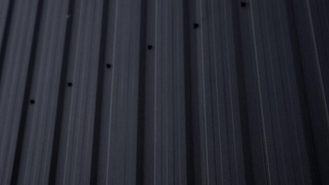Black Corrugated metal sheet surface of the wall. Galvanize steel background.