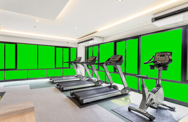 Fototapeta na wymiar A fully equipped gym with green sceen windows