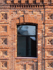The window of the old mansion 19 century with brown bricks wall