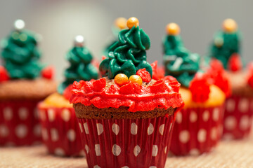 Christmas decorated mini cupcakes with buttercream icing and sprinkles.
