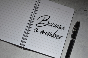 Top angle view of pen and notebook written with text BECOME A MEMBER. Business and education...