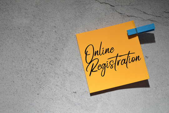 Top angle view of clothespin and memo note written with text ONLINE REGISTRATION. Business and education concept.