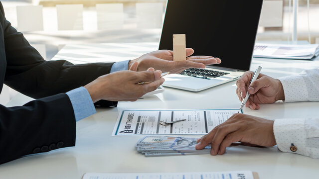 A real estate agent, a home dealer, guides clients after completing a contract and making payments.