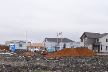 Construction site with concrete, soil, dirt around and crane working