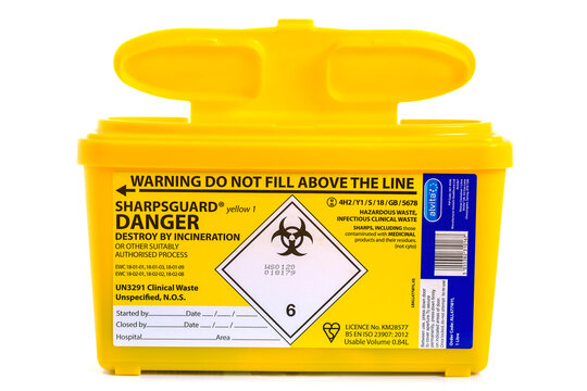 Yellow Sharpsguard biohazard medical contaminated sharps clinical waste container isolated on white background