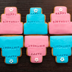 six color cakes made by gingerbread with happy birthday on a dark wooden table, having space for text