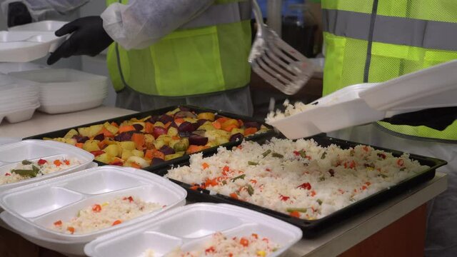 Charity run soup kitchens and meal programs help feed the hungry as well as the low income or homeless. Volunteers work in the kitchen during Christmas holidays. Social service center.