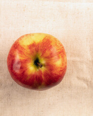 ripe red apples one lying on light cloth. Top view.