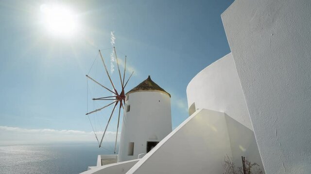 Panoramic view of windmill  under summe sun shining in Oia in Santorini