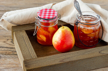 Homemade pear jam in wooden box on background fresh ripe pears