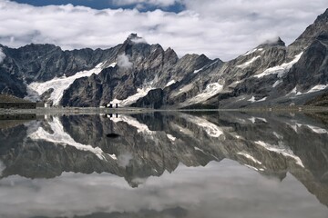 Beautiful mountain lake with reflections. Cervino Ski Resort in summer. Italy. 