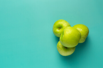 fresh green apples put on light green background