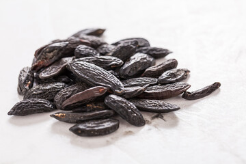 Fragrant tonka beans on white background, baking flavored ingredient