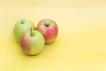 A few apples on yellow background, benefits of apples concept