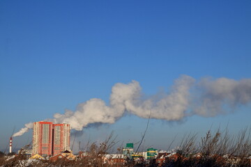 air pollution by emission of smoke on a multi-storey building in a field