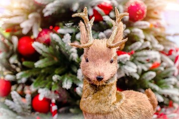 deer with gifts on the background of the Christmas tree
