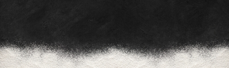 Baking background with flour banner on dark surface with space for text. Top view.