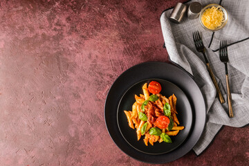 Plate of penne pasta and tomato sauce on   color background