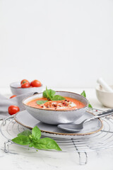 Bowl of tasty tomato cream soup on table