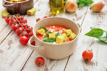 Bowl of tomato cream soup on wooden  table