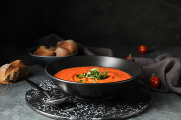 Bowl of tomato cream soup on table