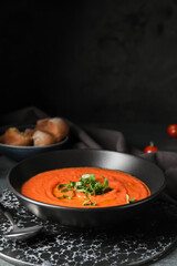 Bowl of tomato cream soup on table