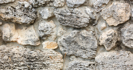 Stones in the wall of the house as an abstract background.