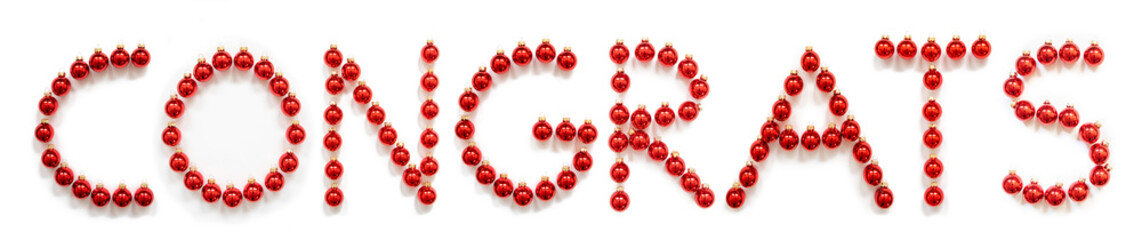 Red Christmas Ball Ornament Building English Word Congrats. Festive Christmas Decoration. White Isolated Background