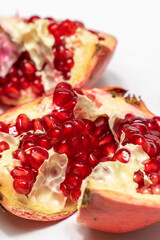 broken pomegranate fruit on a light wooden background