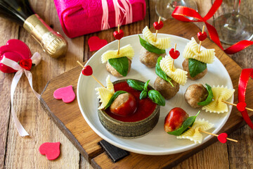 Valentines day or birthday romantic dinner. Spaghetti cooked in the form of canapes, meatballs, served with tomato sauce.