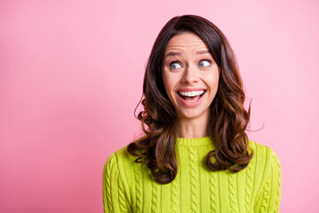 Photo of excited shocked girl open mouth look side empty space wear green sweater isolated pink color background