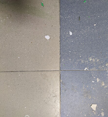 drops of white paint indoors on the floor where repairs are in progress