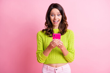 Photo of cheerful excited girl hold telephone open mouth wear green pullover isolated pink color background