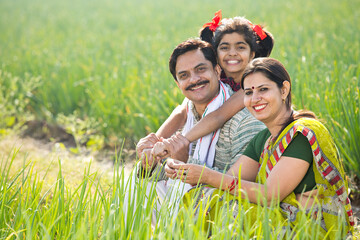 Fototapeta premium Happy Indian family in agricultural field