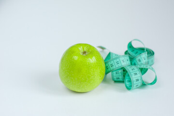 green apple and measuring tape