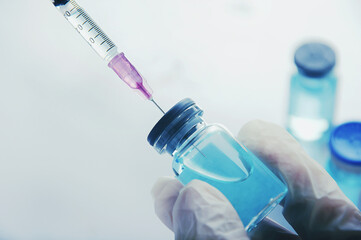 Fototapeta premium Close up,Syringe vaccine testing and prepares for injection Coronavirus,Vaccine vial dose flu