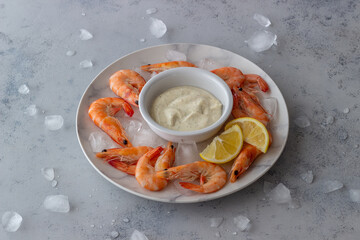Shrimps on ice with white sauce. Healthy eating. Diet. Sea food.