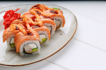 Philadelphia sushi roll served on plate on white table