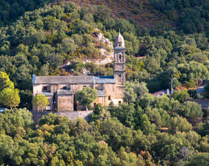 Beautiful view of the 16th century Church of Saint Martin in Patrimonio, a little town of Haute Corse with mountains in the Background, Corsica France