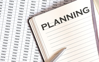 Obraz premium Business concept, on the table a notepad with the text of the PLANNING , profit, loss and graph