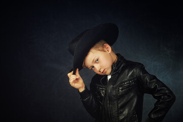 studio portrait of a fashionable boy in a leather jacket