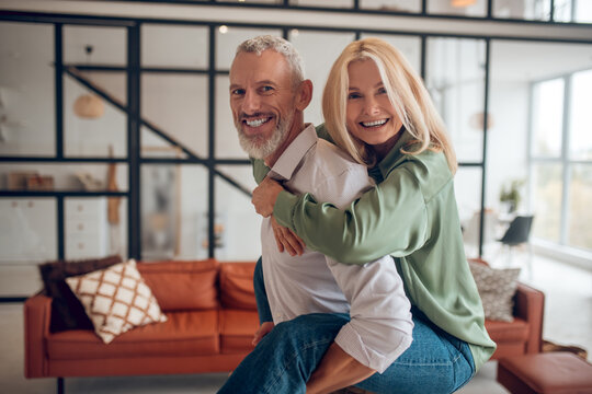 Man holding his wife on his back and both feeling wonderful