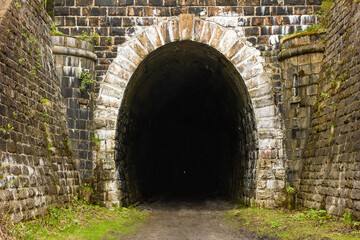 Entrance to the old abandoned railway tunnel, old stone