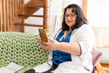 Portrait of a fat woman sitting on a sofa in an apartment