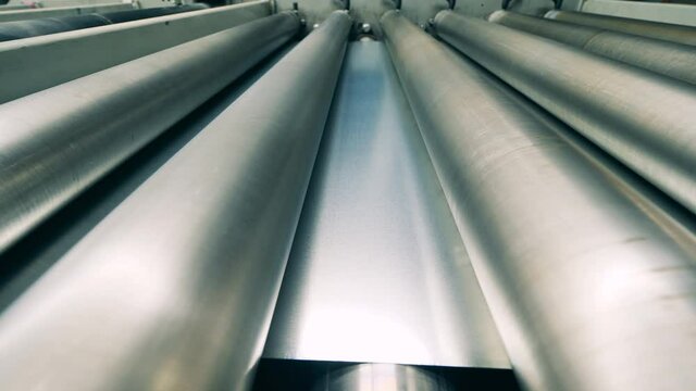Closeup of metal rolling process at rolling mill