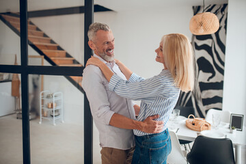 Mature couple looking at each other and feeling happy
