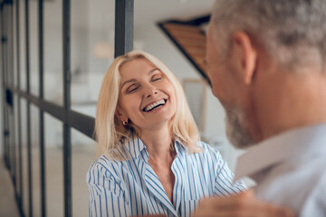 Blonde woman hugging her boyfriend and smiling brightly