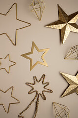 Christmas layout pattern mad with golden stars on neutral beige background. Minimal New year traditional background concept. Flat lay, top view.